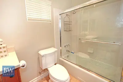 a bathroom with a toilet and a glass shower at 3 Bedrooms in Newport Beach