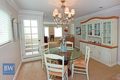 a dining room and kitchen with a glass table and chairs at 3 Bedrooms in Newport Beach