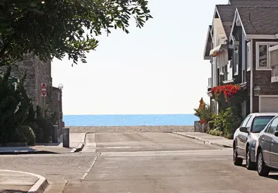 a car parked on a street next to a beach at 4 Bedrooms in Newport Beach