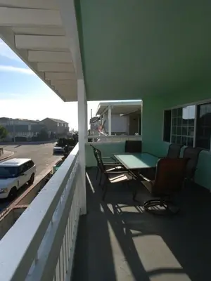 a balcony with a table and chairs on a building at 4 Bedrooms in Newport Beach