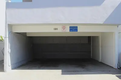 an open garage door with a sign in it at 4 Bedrooms in Newport Beach