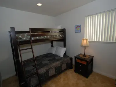 a bedroom with a bunk bed and a table with a lamp at 4 Bedrooms in Newport Beach