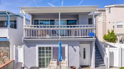 a house with a balcony with two chairs at 3 Bedrooms in Newport Beach