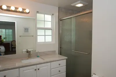 a bathroom with a shower and a sink and a mirror at 3 Bedrooms in Newport Beach
