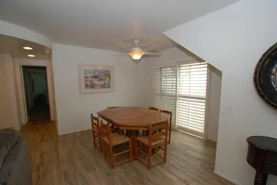 a dining room with a table and chairs and a ceiling fan at 3 Bedrooms in Newport Beach
