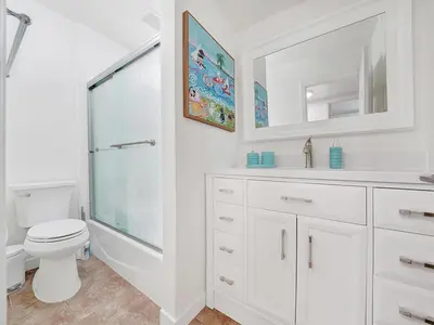 a white bathroom with a toilet and a sink at 3 Bedrooms in Newport Beach