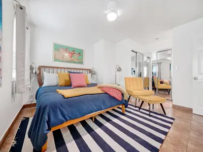 a bedroom with a bed with colorful pillows on it at 3 Bedrooms in Newport Beach