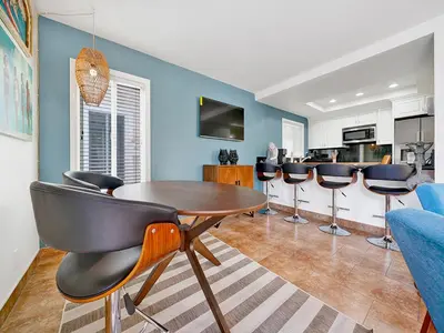 a living room with a table and chairs at 3 Bedrooms in Newport Beach