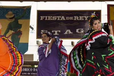 three women in traditional costumes standing in front of a sign at Stylish 1Br Retreat With Garage AC Close 2 Everything in San Diego