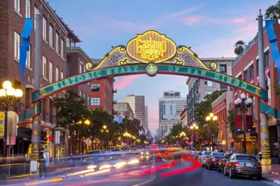 a sign over a city street with cars driving under it at Stylish 1Br Retreat With Garage AC Close 2 Everything in San Diego