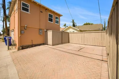 a house with a fence and a brick driveway at Stylish 1Br Retreat With Garage AC Close 2 Everything in San Diego