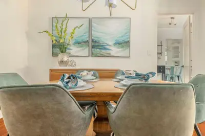 a dining room with a wooden table and chairs at Elegant 3Br Home with AC, Parking, & Close 2 Everything in San Diego