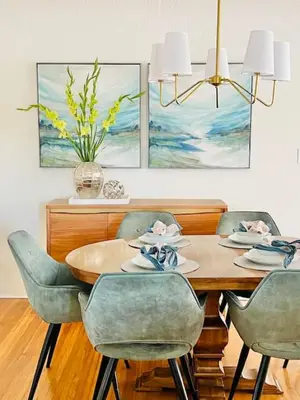a dining room table with four chairs and a vase at Elegant 3Br Home with AC, Parking, & Close 2 Everything in San Diego