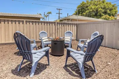 a group of chairs sitting around a fire pit at Elegant 3Br Home with AC, Parking, & Close 2 Everything in San Diego