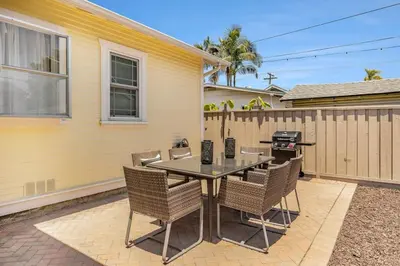 a patio with a table and chairs and a grill at Elegant 3Br Home with AC, Parking, & Close 2 Everything in San Diego