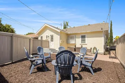 a patio with chairs and a table and a fence at Elegant 3Br Home with AC, Parking, & Close 2 Everything in San Diego