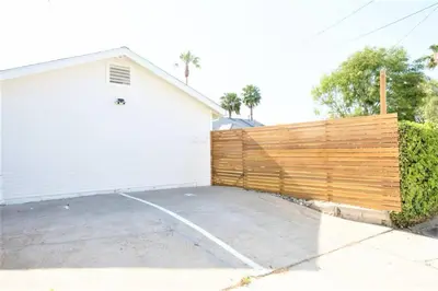 a wooden fence in front of a garage at Chic 2Bed And Large Serene Backyard in Heart of SD in San Diego