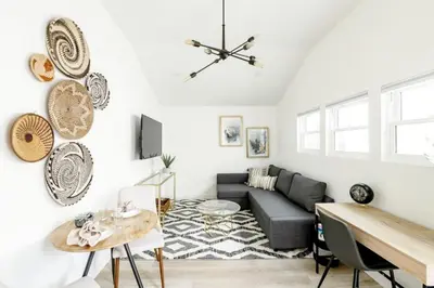 a living room with a couch and a table at Chic 2Bed And Large Serene Backyard in Heart of SD in San Diego