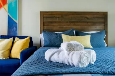 a bed with towels sitting on top of it at Chic Studio Suite Serene Backyard in Heart of SD in San Diego