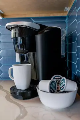 a coffee maker sitting on a counter next to a cup at Chic Studio Suite Serene Backyard in Heart of SD in San Diego