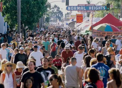 a large crowd of people walking down a busy street at Chic Studio Suite Serene Backyard in Heart of SD in San Diego