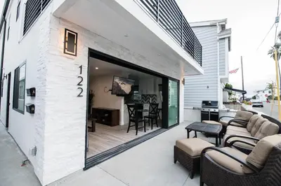 an outdoor patio with chairs and a table at Upper West Newport in Newport Beach