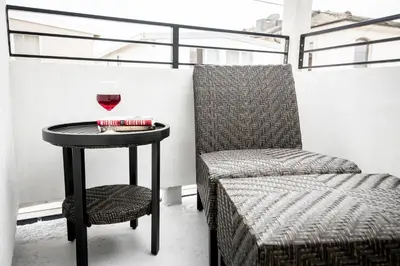 a table with a glass of wine and a chair at 3 Bedrooms in Newport Beach