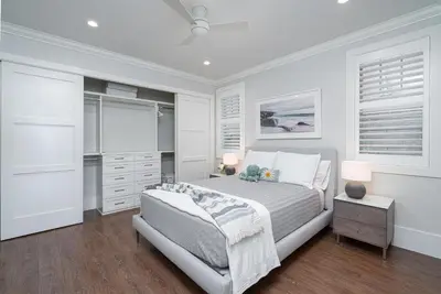 a white bedroom with a bed and a dresser at 1225 W Balboa Blvd A in Newport Beach