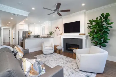 a living room with a couch and a fireplace at 1225 W Balboa Blvd A in Newport Beach