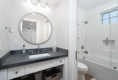 a white bathroom with a sink and a mirror at 1225 W Balboa Blvd A in Newport Beach