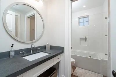 a bathroom with a sink and a mirror and a toilet at 1225 W Balboa Blvd A in Newport Beach
