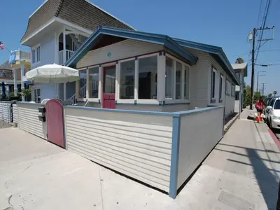 a building with a restaurant on the side of a street at Lower West Newport in Newport Beach