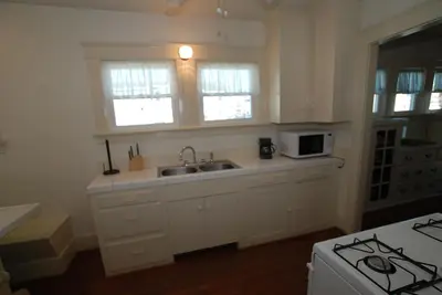 a kitchen with a sink and a microwave at Lower West Newport in Newport Beach