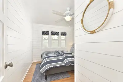 a bedroom with a bed and a mirror at 129 G St in Newport Beach