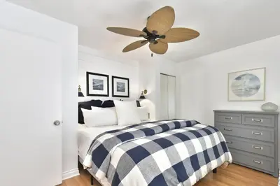 a bedroom with a bed and a ceiling fan at 129 G St in Newport Beach