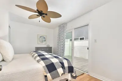 a bedroom with a ceiling fan and a bed at 129 G St in Newport Beach