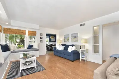 a living room with a blue couch and a table at 129 G St in Newport Beach