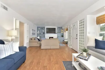 a living room with a blue couch and a table at 129 G St in Newport Beach