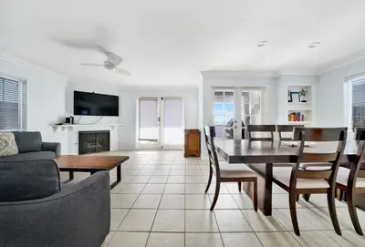 a living room with a table and a dining room at 1404 W Oceanfront A in Newport Beach