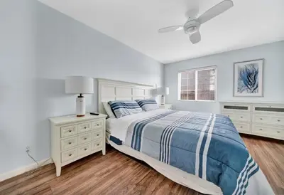 a white bedroom with a bed and a window at 1404 W Oceanfront A in Newport Beach