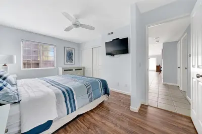 a bedroom with a bed and a flat screen tv at 1404 W Oceanfront A in Newport Beach