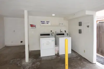 a laundry room with a washer and dryer in it at 1404 W Oceanfront A in Newport Beach