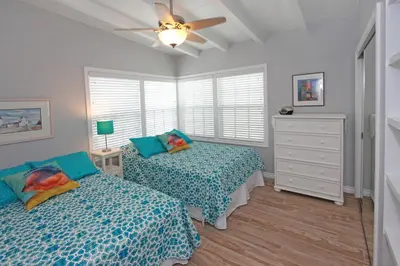 a bedroom with two beds and a ceiling fan at 1759 Miramar Dr in Newport Beach