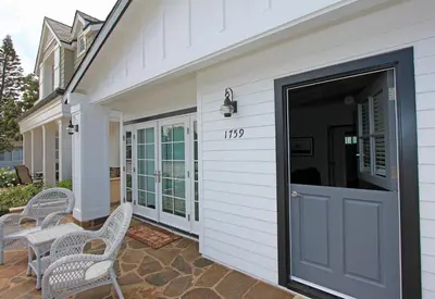 a front door of a house with chairs on a patio at 1759 Miramar Dr in Newport Beach
