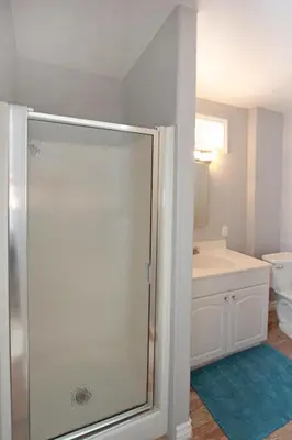 a bathroom with a shower with a sink and a toilet at 1759 Miramar Dr in Newport Beach