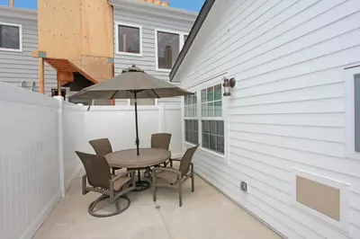 a patio with a table and chairs and an umbrella at 1759 Miramar Dr in Newport Beach