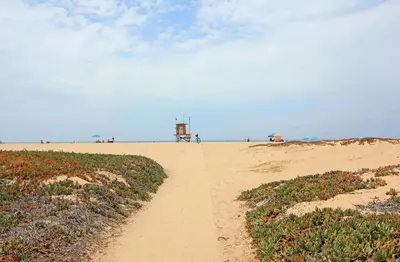 a dirt road leading to a beach with a lighthouse at 1759 Miramar Dr in Newport Beach