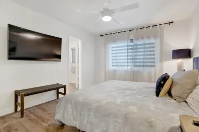 a bedroom with a bed and a ceiling fan at 1807 W Bay Unit B in Newport Beach