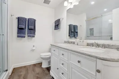 a white bathroom with a sink and a toilet at 1807 W Bay Unit B in Newport Beach
