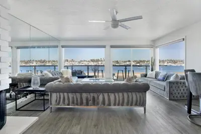a living room with a couch and a ceiling fan at 1807 W Bay Unit B in Newport Beach
